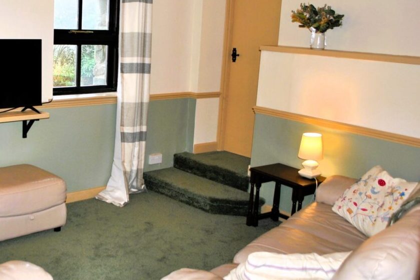 Two steps leading from the living room to the twin bedroom